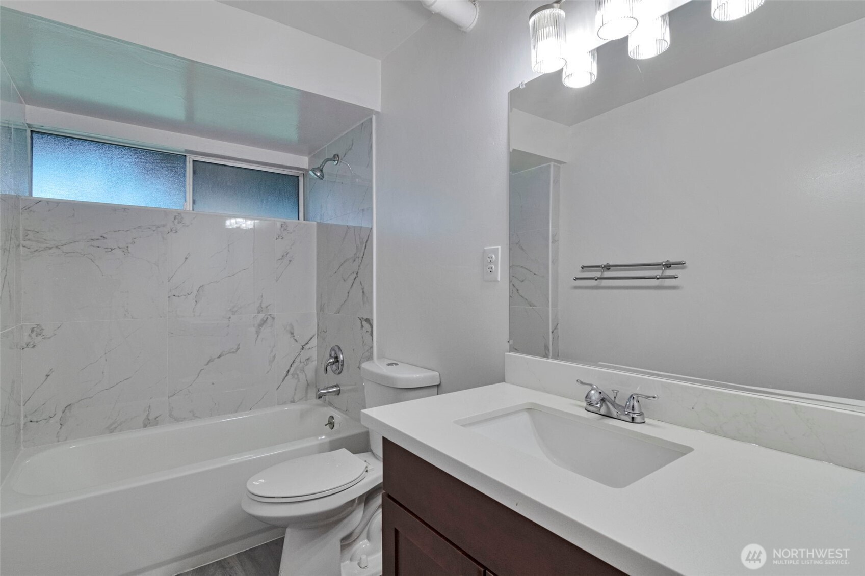 25810 129th Place Southeast Kent, WA 98030 - Photo 19 of 25 a bathroom with a sink a toilet a mirror a bathtub and shower