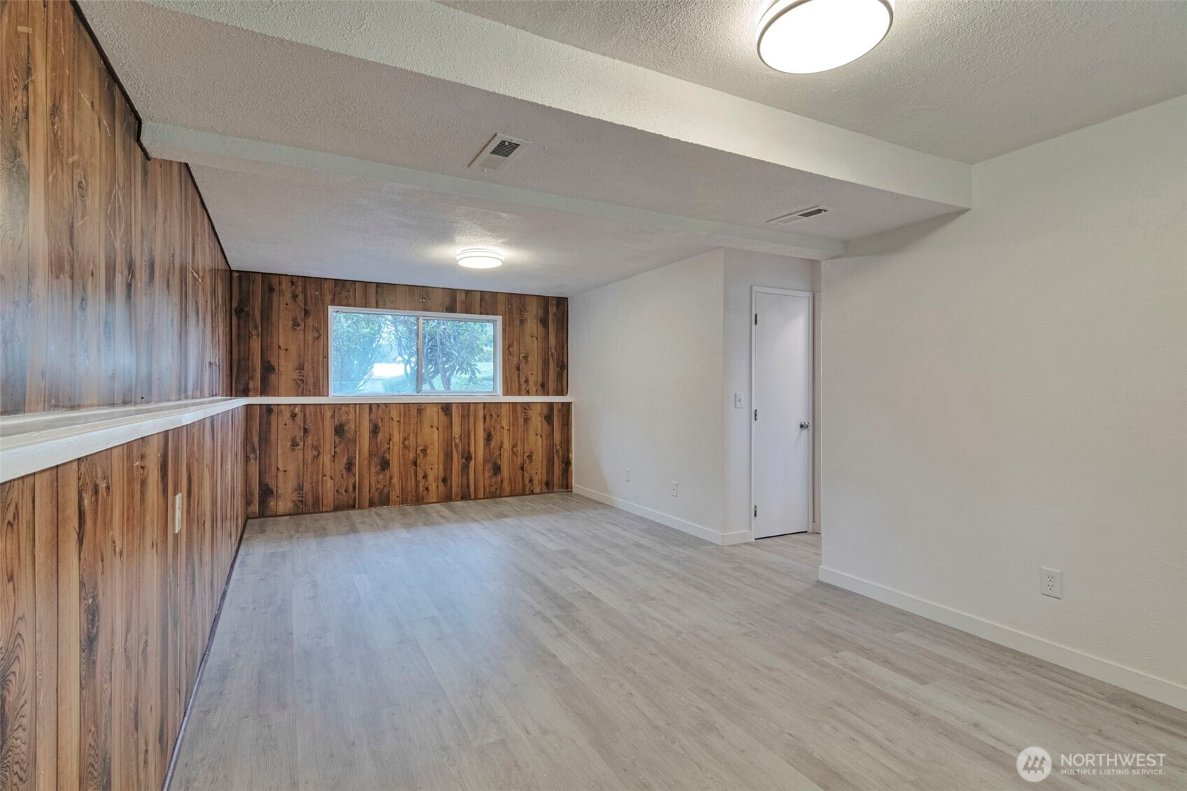 25810 129th Place Southeast Kent, WA 98030 - Photo 21 of 25 a view of an empty room with wooden floor and fan