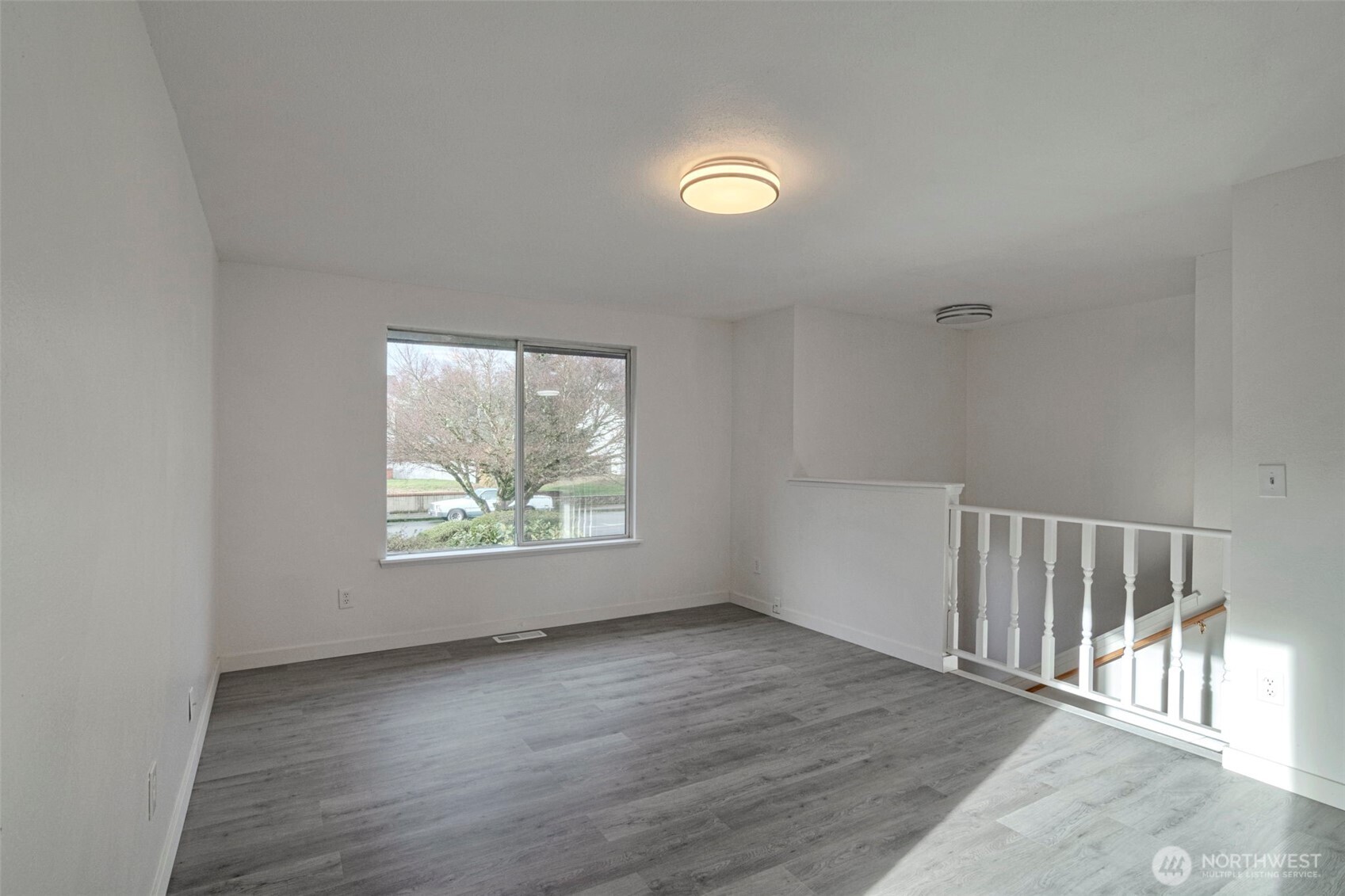 25810 129th Place Southeast Kent, WA 98030 - Photo 4 of 25 an empty room with wooden floor and windows