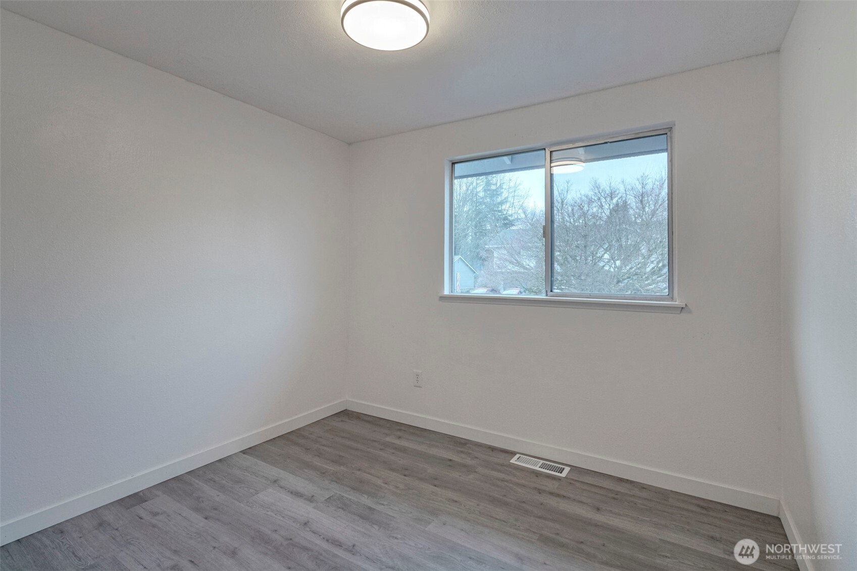 25810 129th Place Southeast Kent, WA 98030 - Photo 8 of 25 a view of an empty room with wooden floor and a window