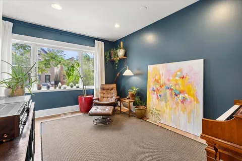 a living room with furniture a rug and a large window