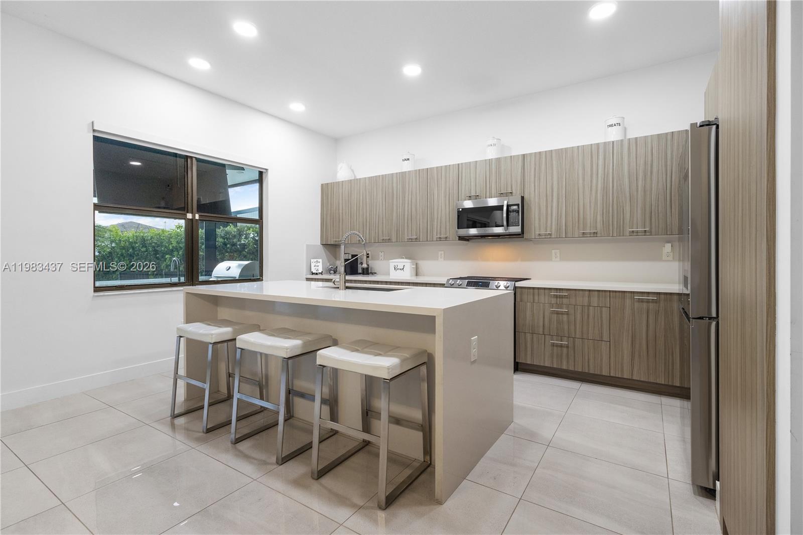 4335 Southwest 174th Avenue Miramar, FL 33029 - Photo 12 of 58 a kitchen with a sink a counter top space and stainless steel appliances