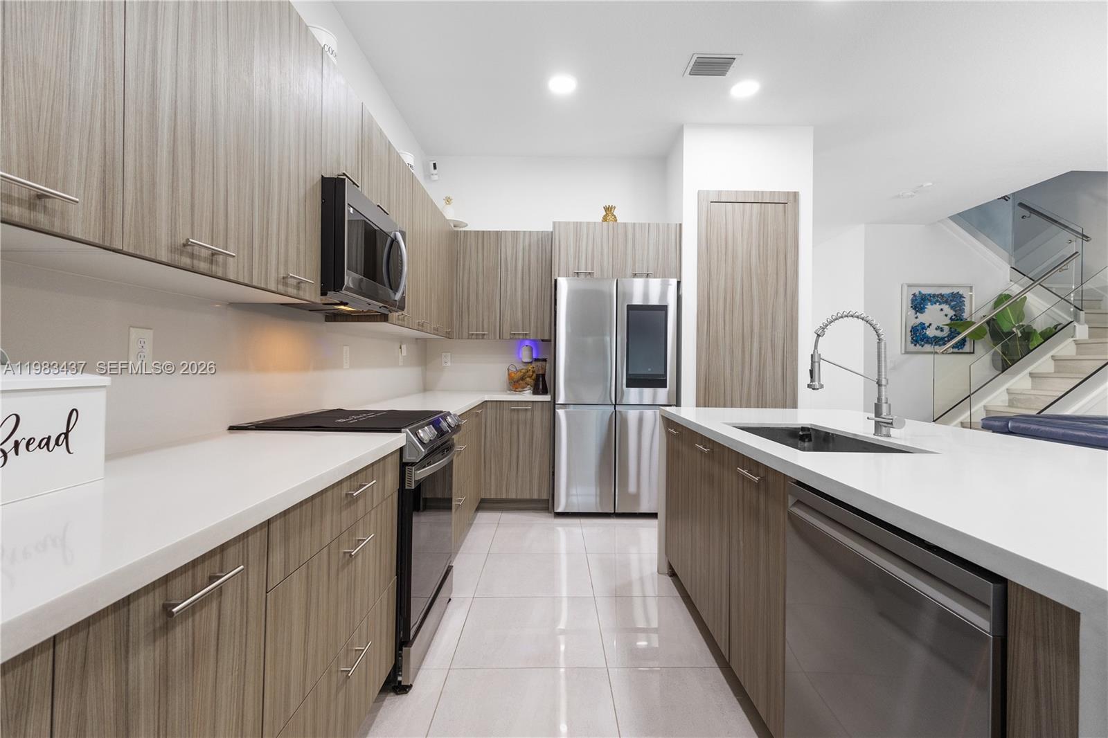 4335 Southwest 174th Avenue Miramar, FL 33029 - Photo 14 of 58 a kitchen with stainless steel appliances granite countertop a sink a stove and a refrigerator