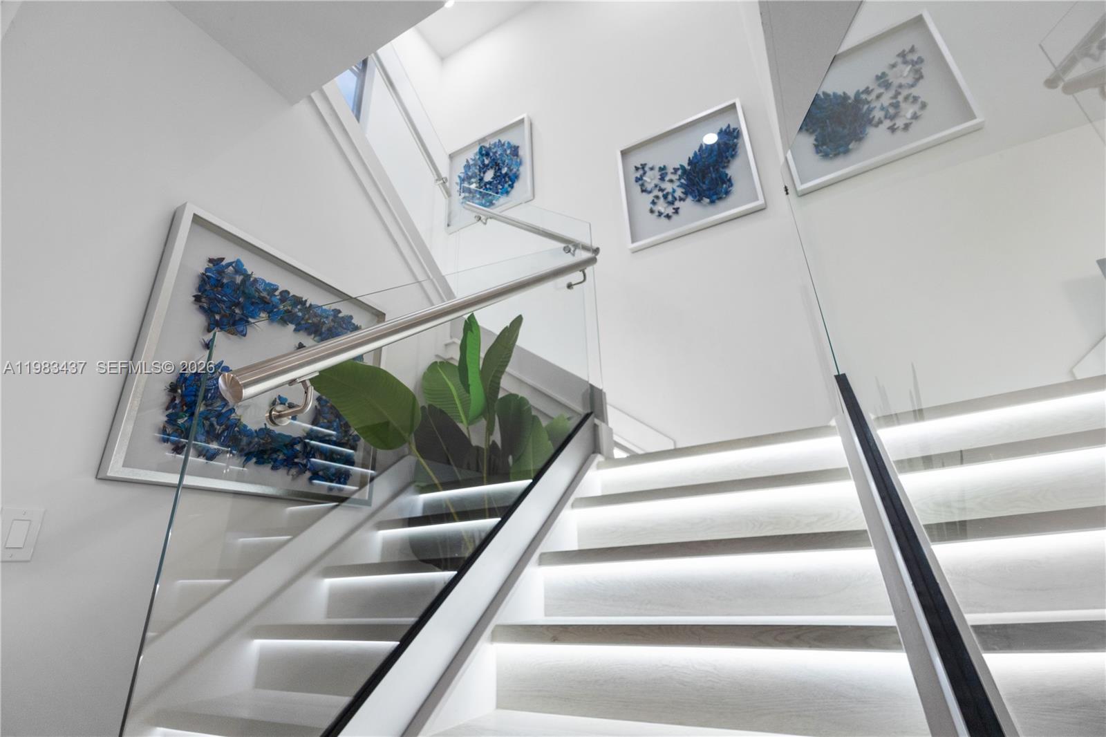 4335 Southwest 174th Avenue Miramar, FL 33029 - Photo 18 of 58 a view of staircase with lots of frames on wall and a picture of a window