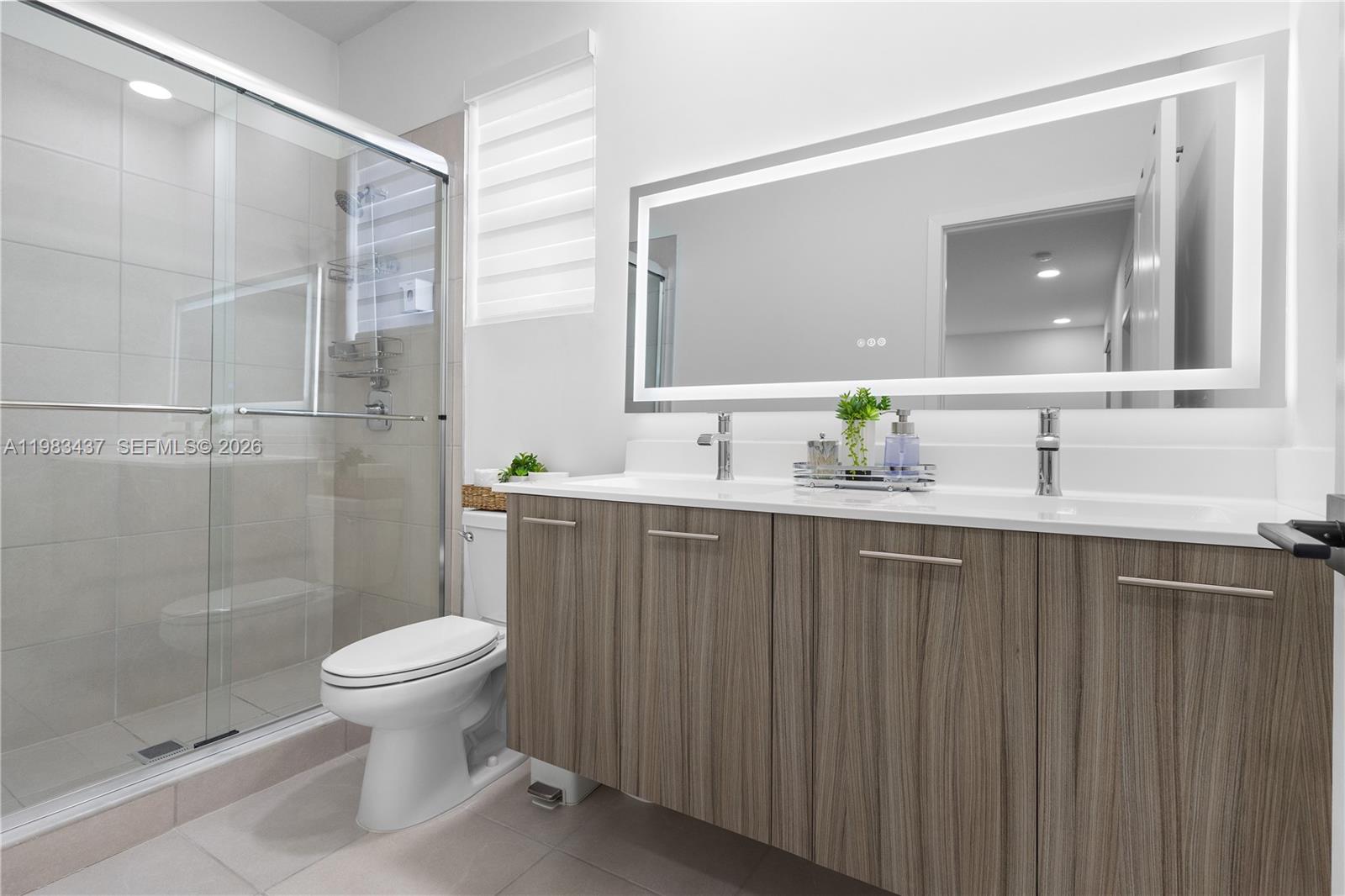 4335 Southwest 174th Avenue Miramar, FL 33029 - Photo 26 of 58 a bathroom with a sink a toilet and shower
