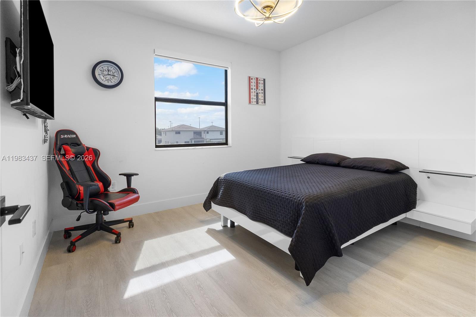 4335 Southwest 174th Avenue Miramar, FL 33029 - Photo 31 of 58 a bedroom with a bed and a chair
