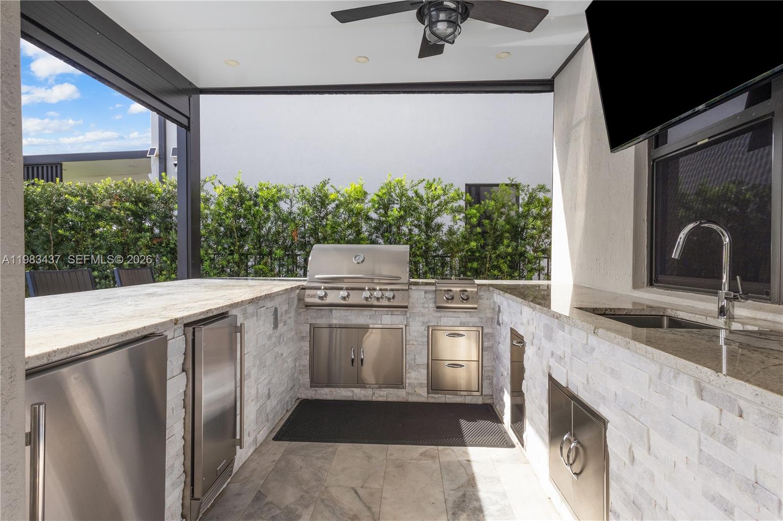 4335 Southwest 174th Avenue Miramar, FL 33029 - Photo 40 of 58 a kitchen with a sink and a stove top oven