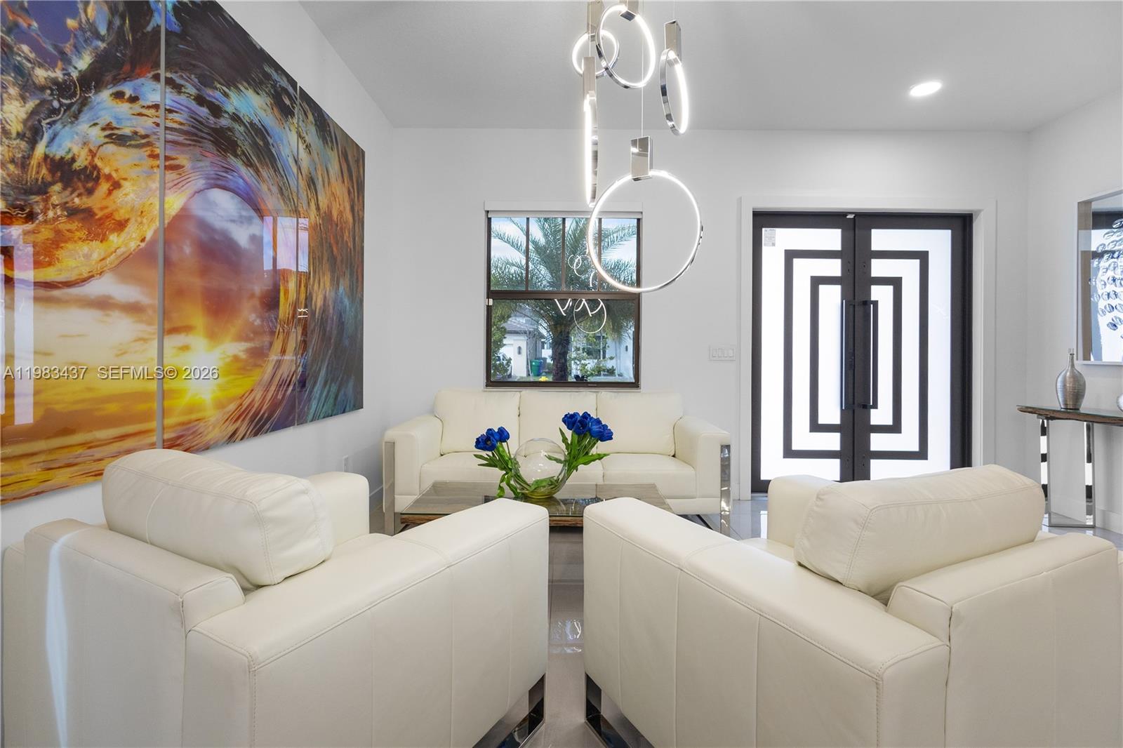 4335 Southwest 174th Avenue Miramar, FL 33029 - Photo 6 of 58 a living room with furniture and a chandelier