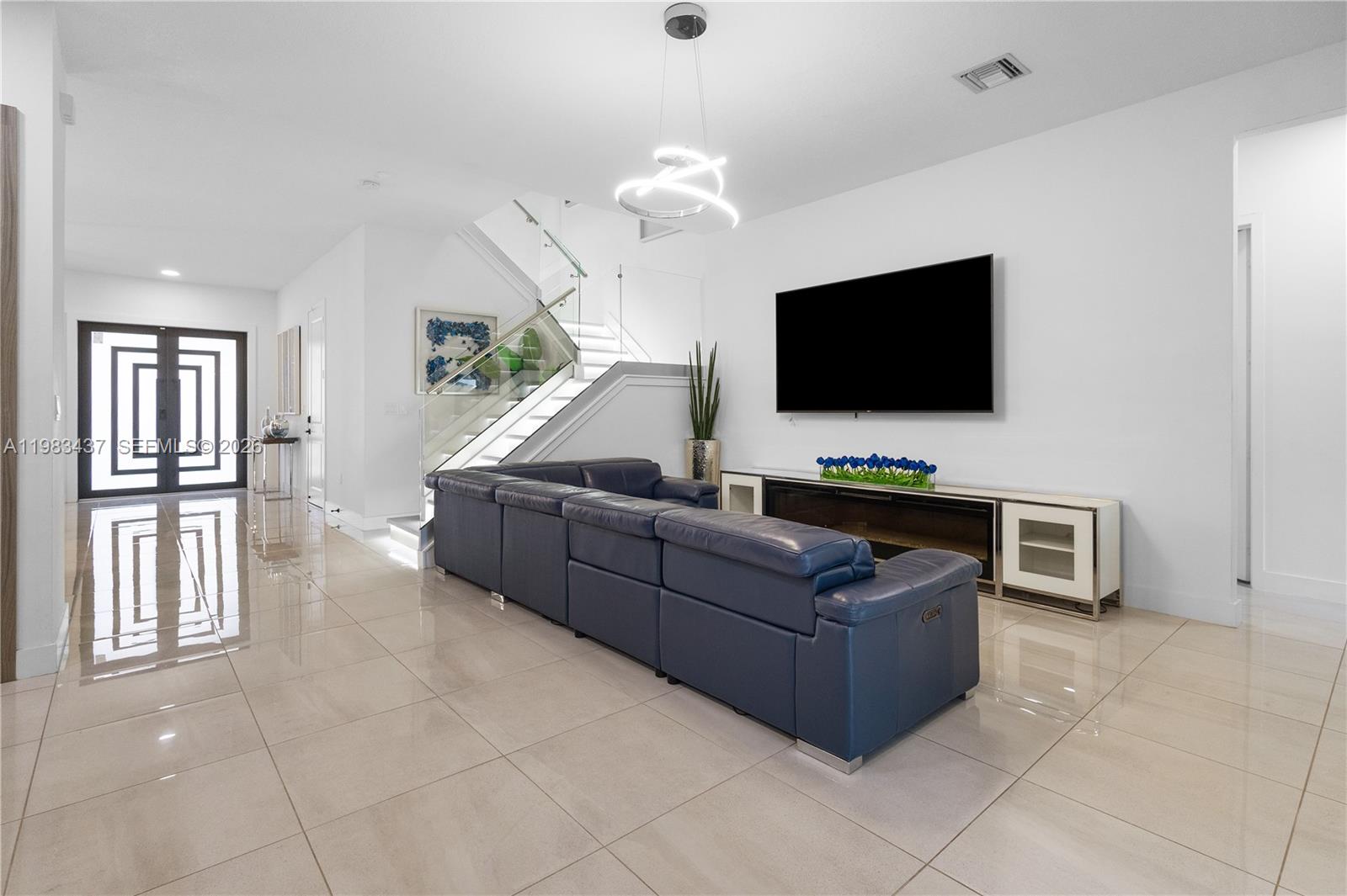 4335 Southwest 174th Avenue Miramar, FL 33029 - Photo 8 of 58 a living room with furniture and a flat screen tv
