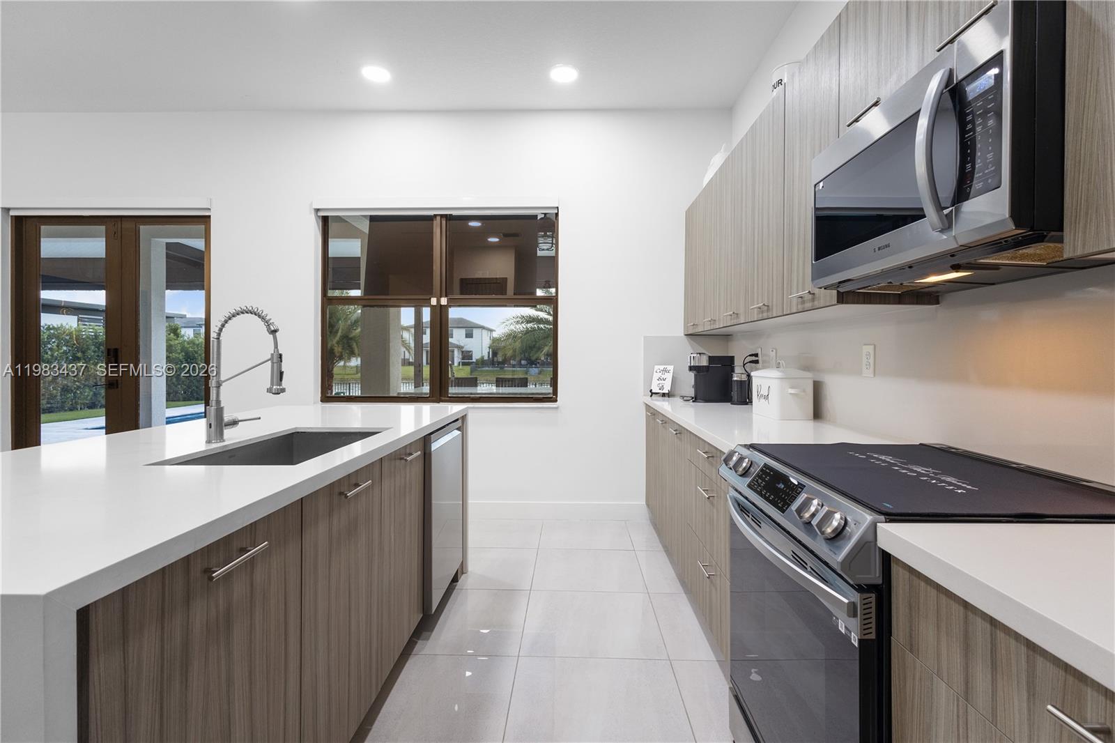 4335 Southwest 174th Avenue Miramar, FL 33029 - Photo 9 of 58 a kitchen with stainless steel appliances granite countertop a sink and a stove