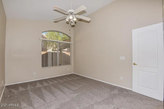 an empty room with a window and mirror