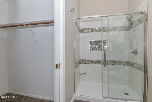 a bathroom with a glass shower door