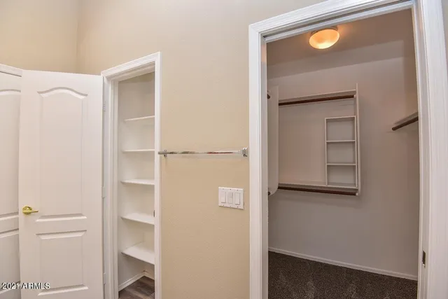 a view of walk in closet with empty racks
