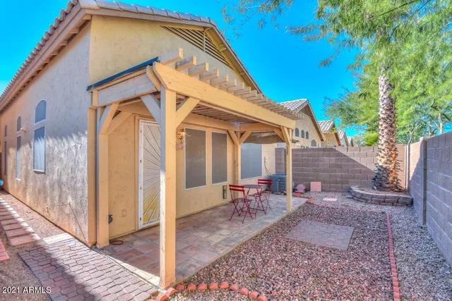a view of a house with backyard and sitting area
