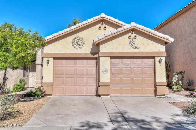 a front view of a house with a garage