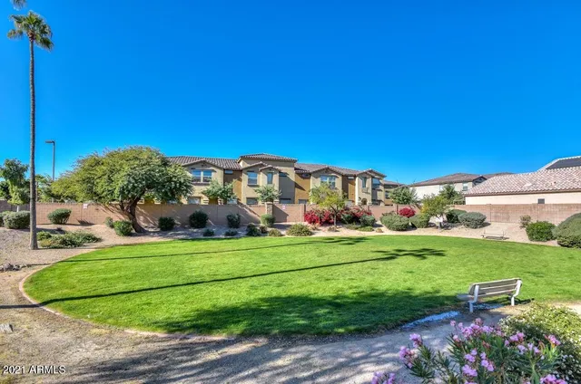 a view of a table and chairs in backyard