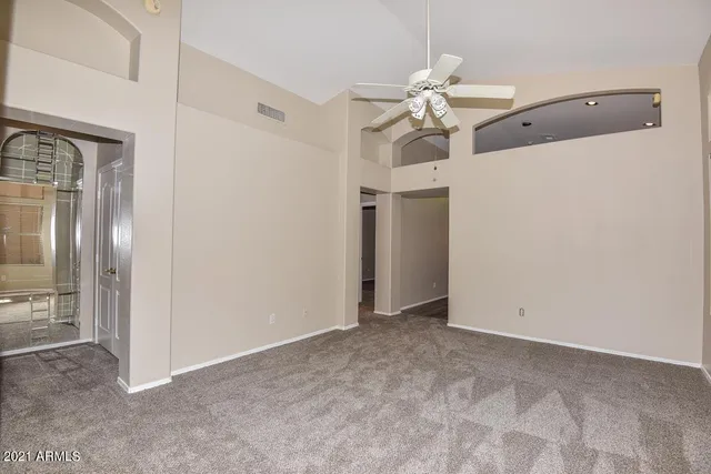 a view of a chandelier fan and refrigerator in a kitchen