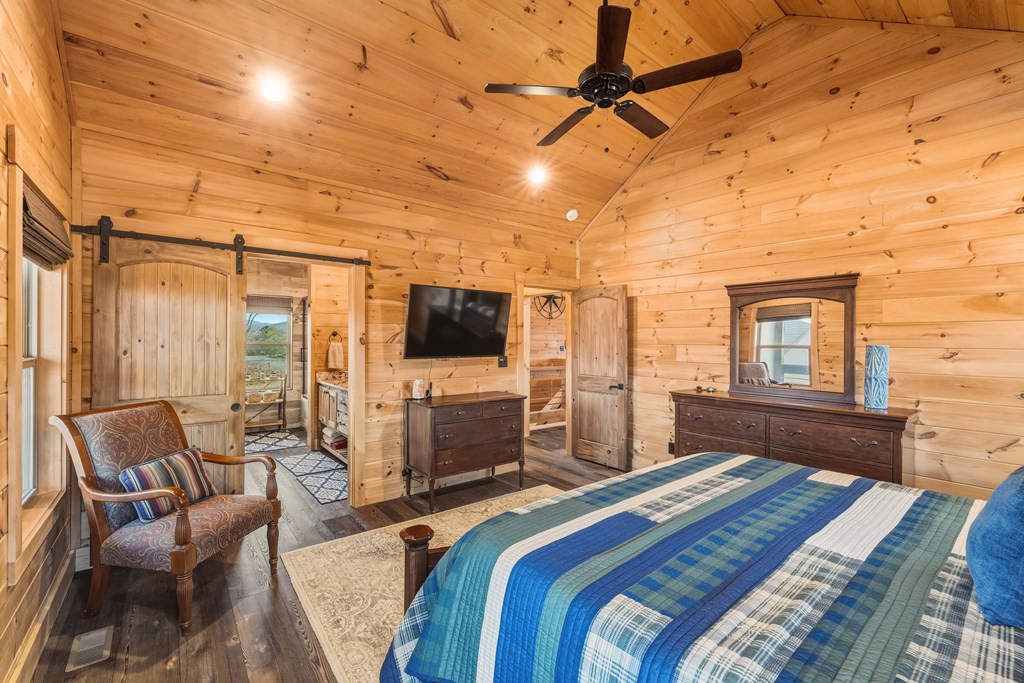 102 High Mdws Trail Morganton, GA 30560 - Photo 15 of 45 a bedroom with a bed a flat screen tv and balcony view