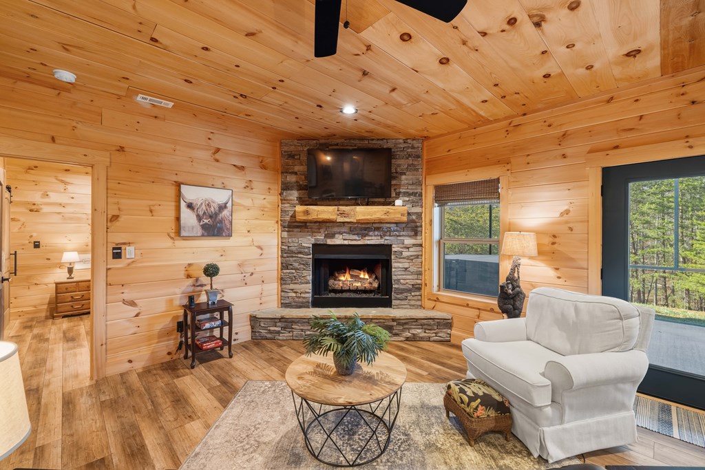 102 High Mdws Trail Morganton, GA 30560 - Photo 24 of 45 a living room with furniture a fireplace and a flat screen tv