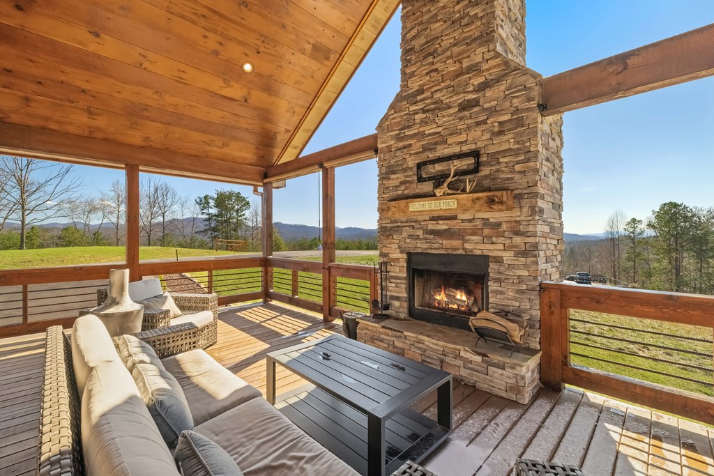102 High Mdws Trail Morganton, GA 30560 - Photo 4 of 45 a balcony with furniture and a fireplace