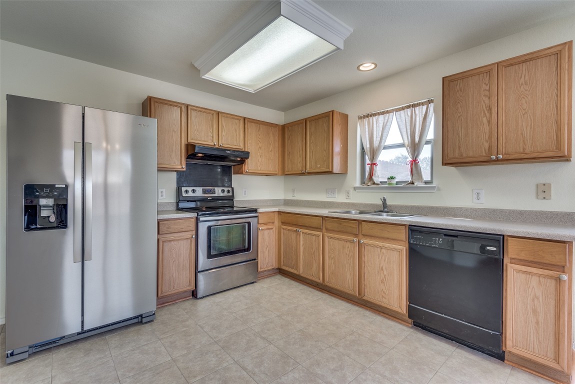 5701 Viewpoint Drive Austin, TX 78744 - Photo 12 of 25 a kitchen with a refrigerator sink and microwave