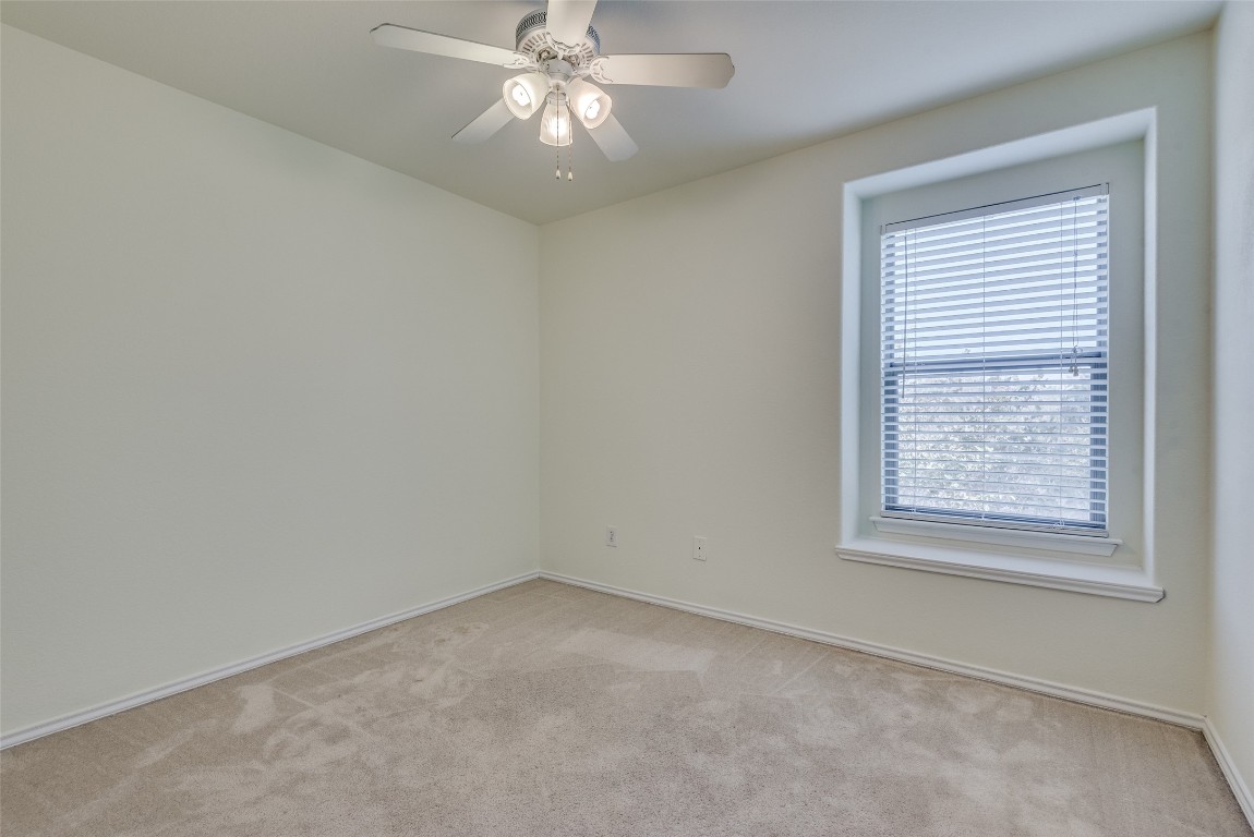 5701 Viewpoint Drive Austin, TX 78744 - Photo 21 of 25 an empty room with a window and a fan