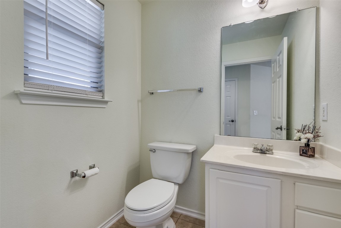 5701 Viewpoint Drive Austin, TX 78744 - Photo 22 of 25 a bathroom with a toilet a sink and mirror