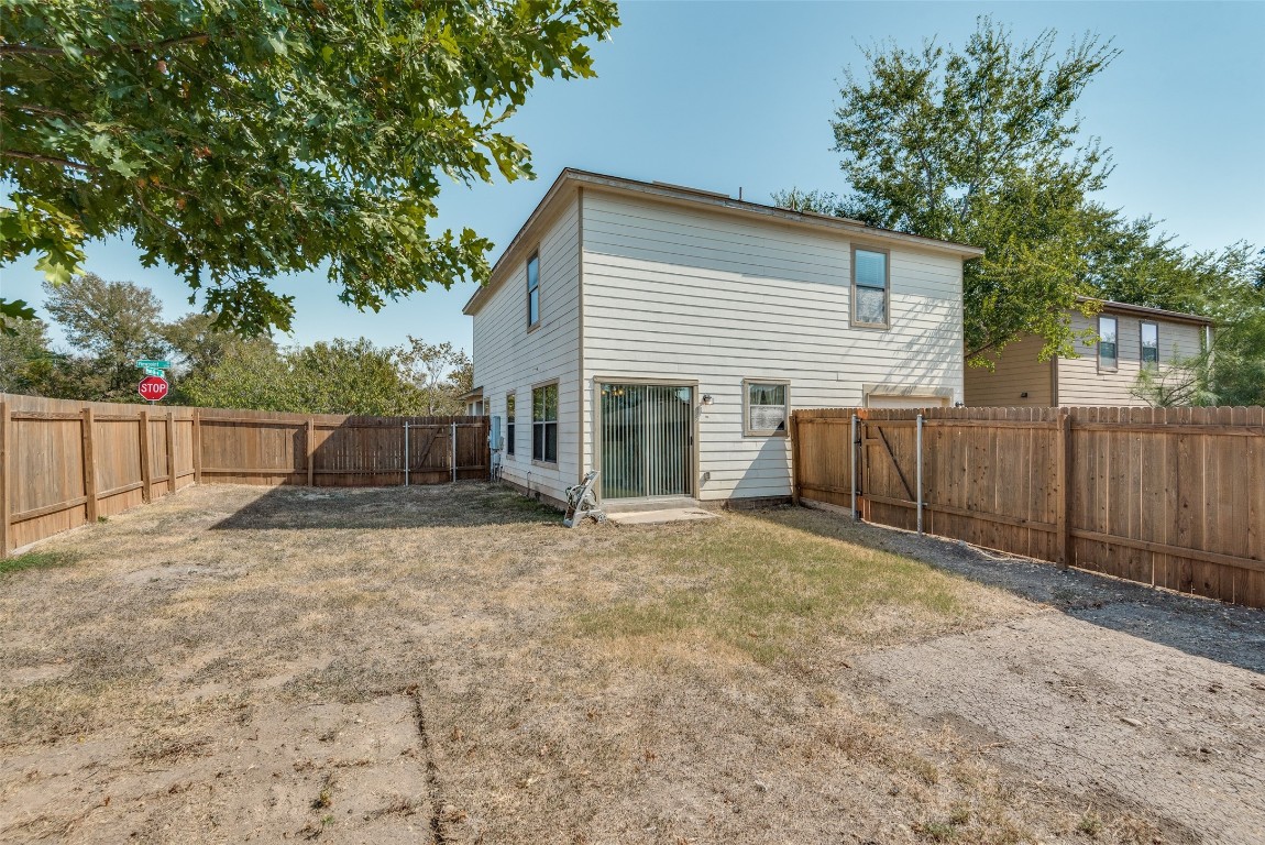 5701 Viewpoint Drive Austin, TX 78744 - Photo 25 of 25 a view of a backyard with wooden fence and a large tree