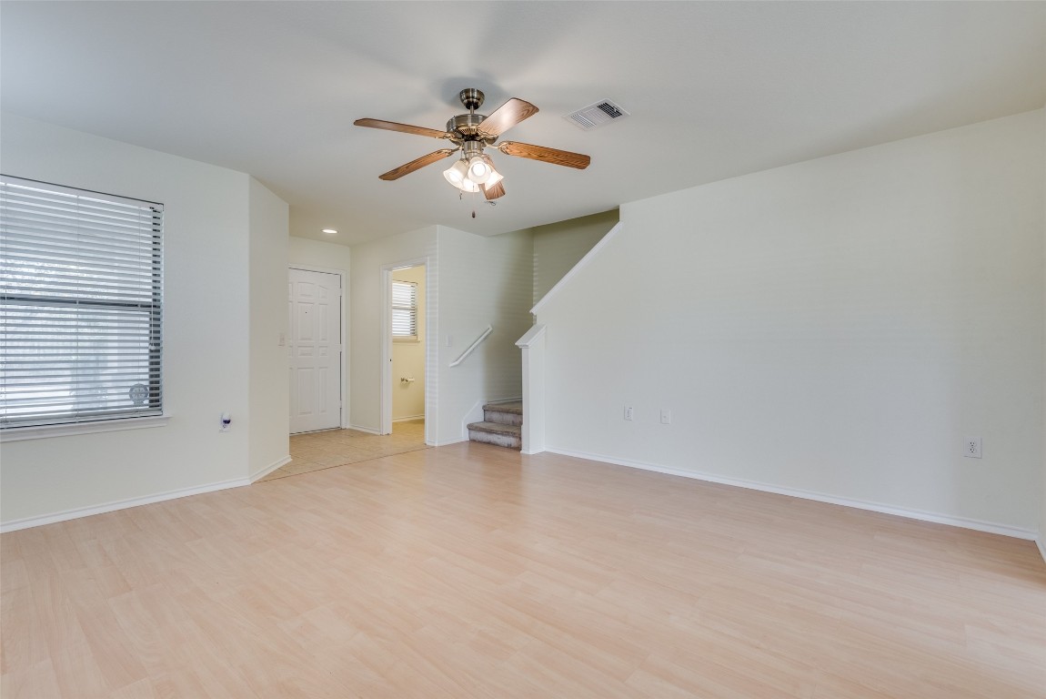 5701 Viewpoint Drive Austin, TX 78744 - Photo 6 of 25 an empty room with windows and fan