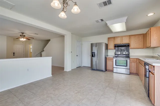 a large kitchen with cabinets and stainless steel appliances