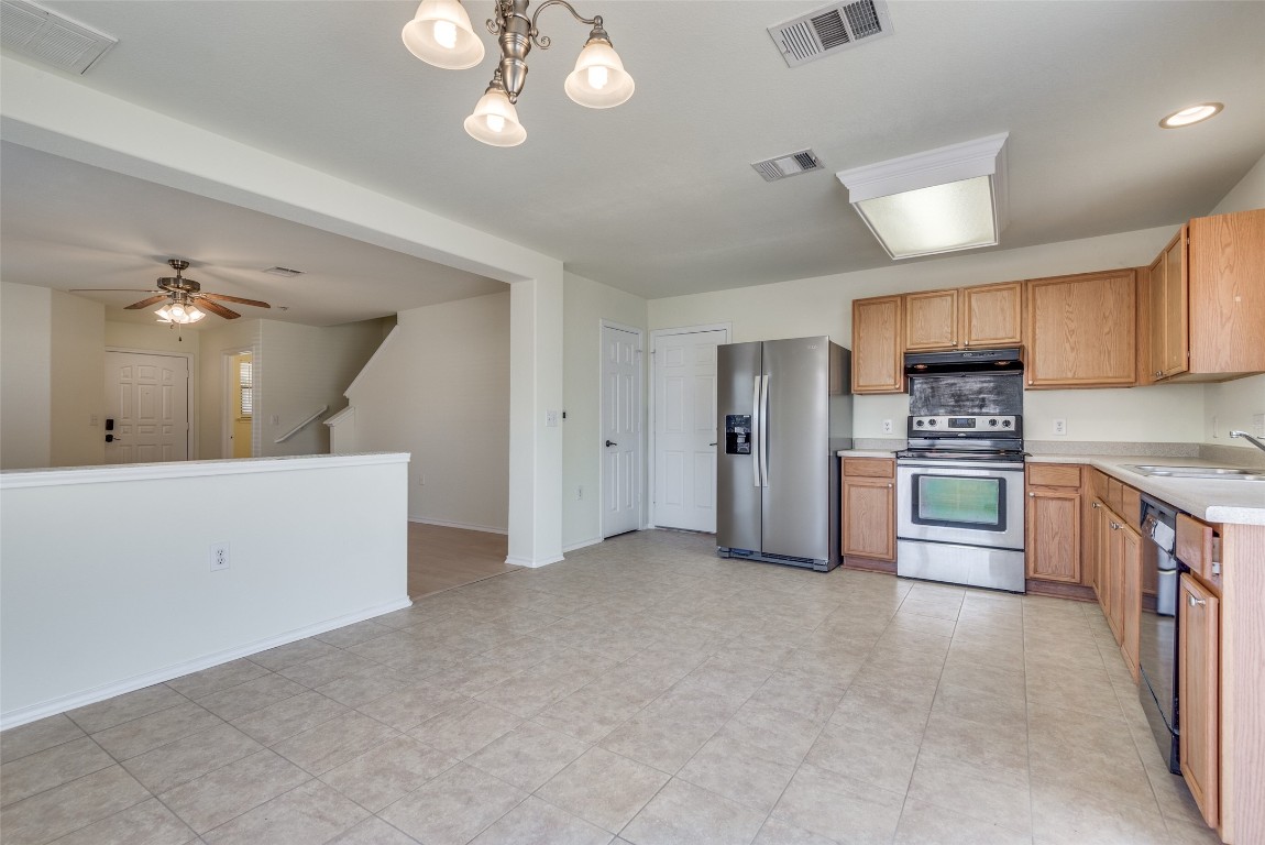 5701 Viewpoint Drive Austin, TX 78744 - Photo 9 of 25 a large kitchen with cabinets and stainless steel appliances