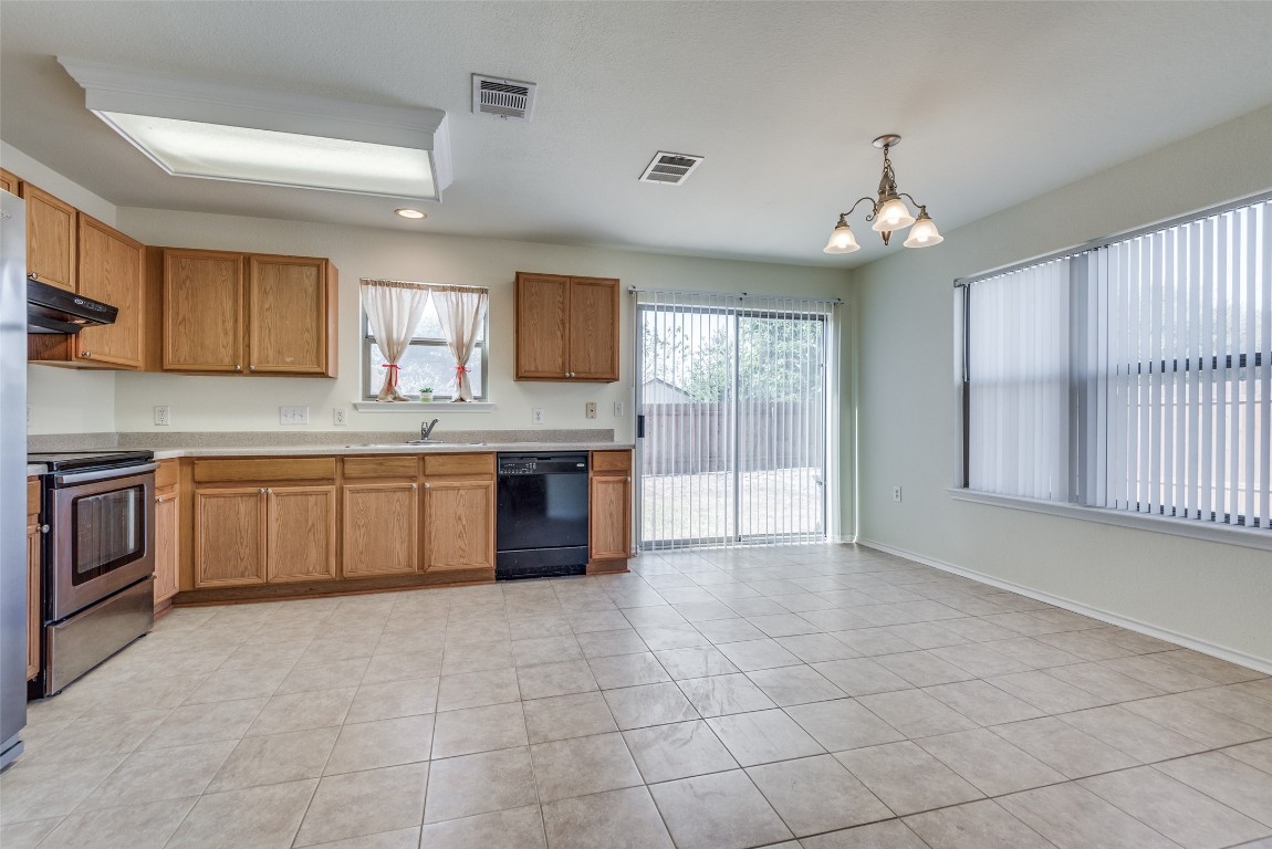 5701 Viewpoint Drive Austin, TX 78744 - Photo 10 of 25 a kitchen with a stove a sink and a refrigerator