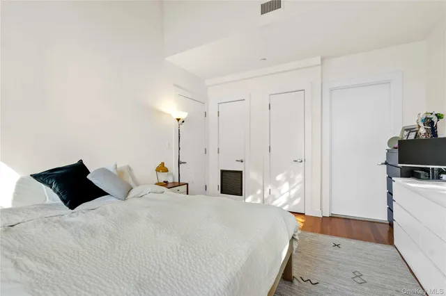 a bedroom with bed and a night stand