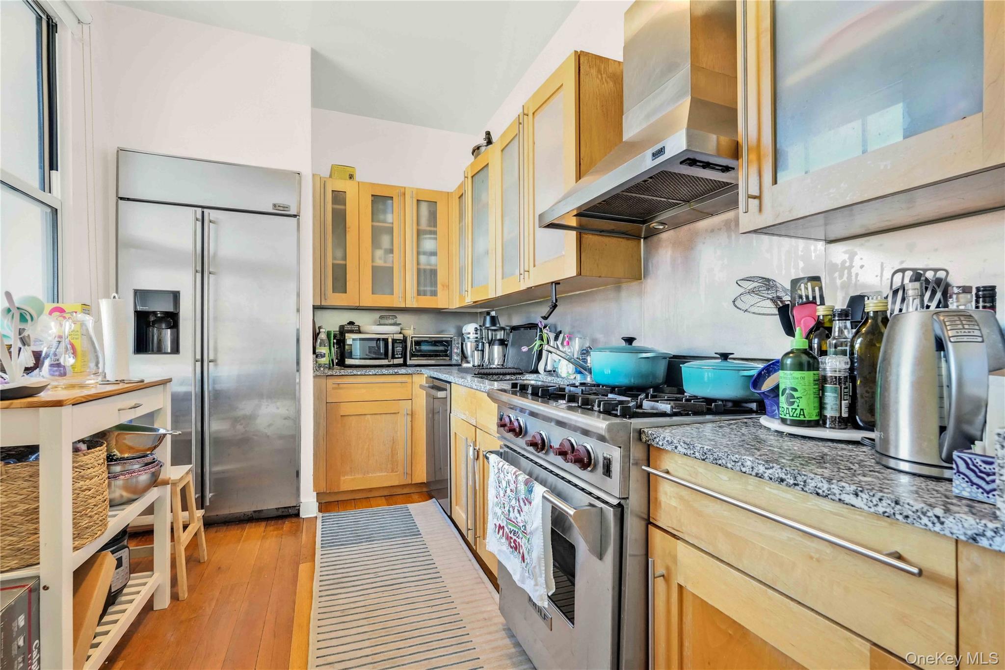 401 Hicks Street, Unit 5B Brooklyn, NY 11201 - Photo 3 of 28 a kitchen with stainless steel appliances granite countertop a stove a sink and a refrigerator