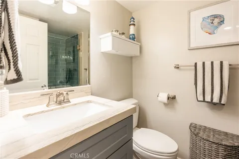 a bedroom with a bed a chandelier and a window