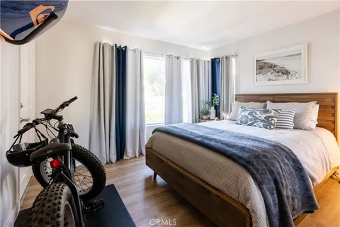 a bedroom with bed and a mirror