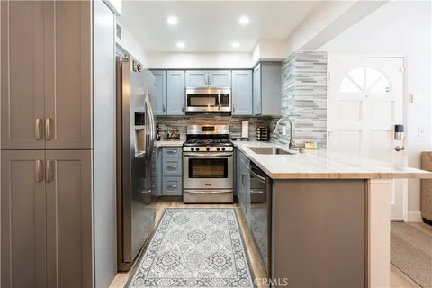 a kitchen with stainless steel appliances granite countertop a stove and a refrigerator