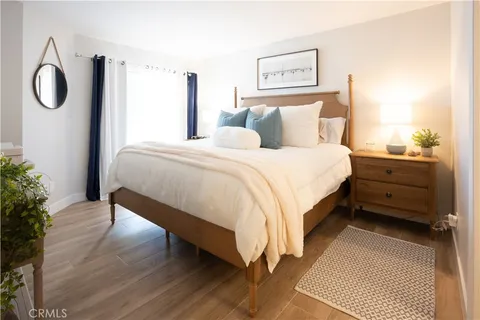 a bedroom with a bed and a potted plant