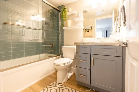 a bedroom with bed and wooden floor