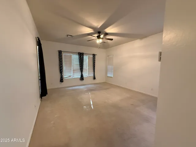 an empty room with windows and closet