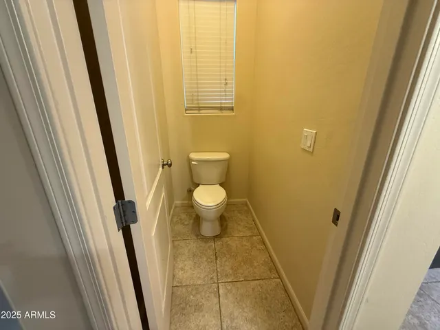 an empty room with a ceiling fan and a window