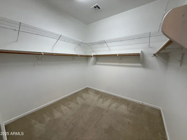 a bathroom with a granite countertop sink a toilet and mirror