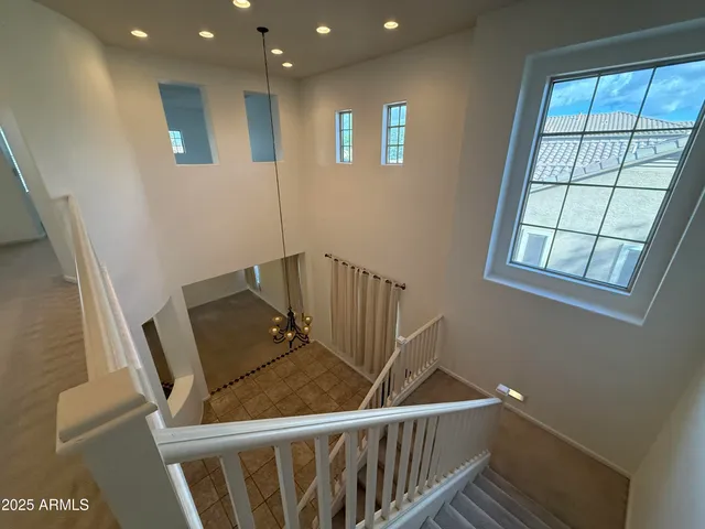 an empty room with a ceiling fan and a window