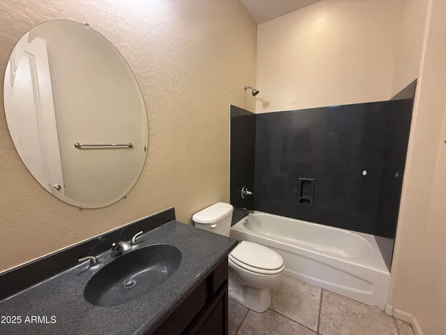 a kitchen with stainless steel appliances kitchen island granite countertop a refrigerator and a sink