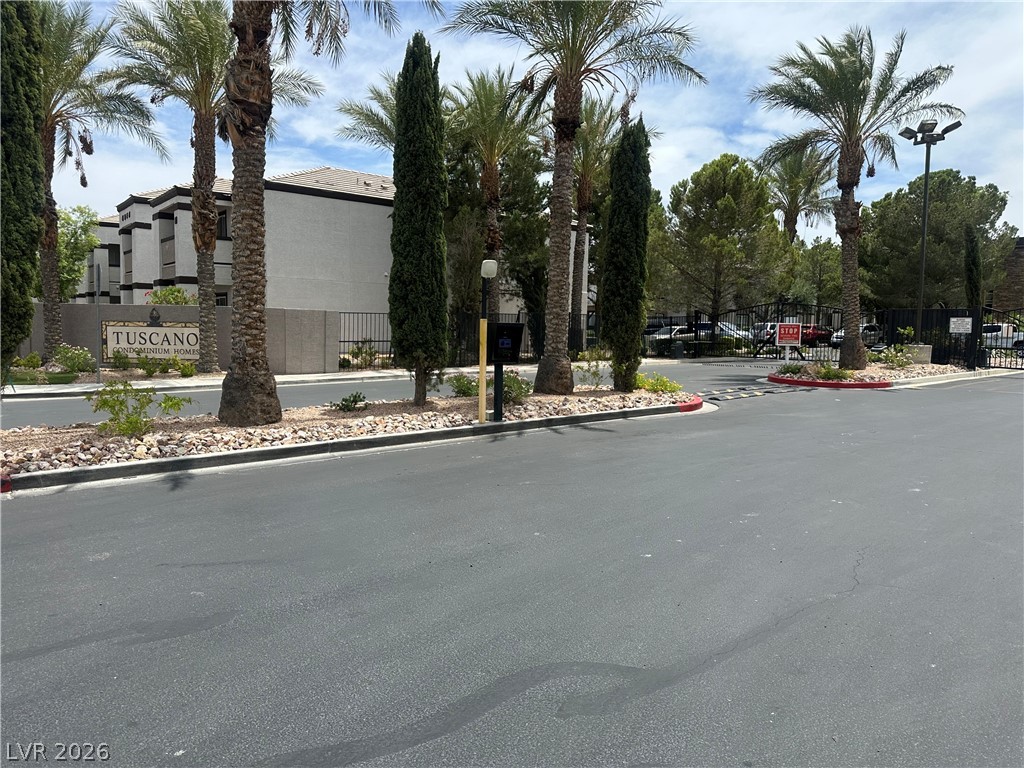 7255 West Sunset Road, Unit 2006 Las Vegas, NV 89113 - Photo 23 of 24 A secured community entrance framed by mature palm trees and lush landscaping.