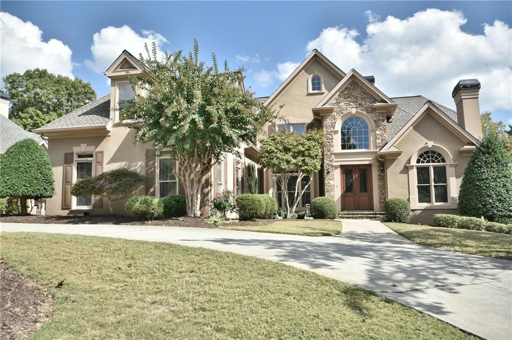 WELCOME HOME!  THIS LUXURIOUS hardcoat stucco and stone estate is situated on a quiet cul-de-sac street with a circular drive, 3 car garage and a large, private backyard with stone waterfall is ready for pool, playset and/or any outdoor feature desired!