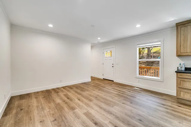 wooden floor in an empty room with a window