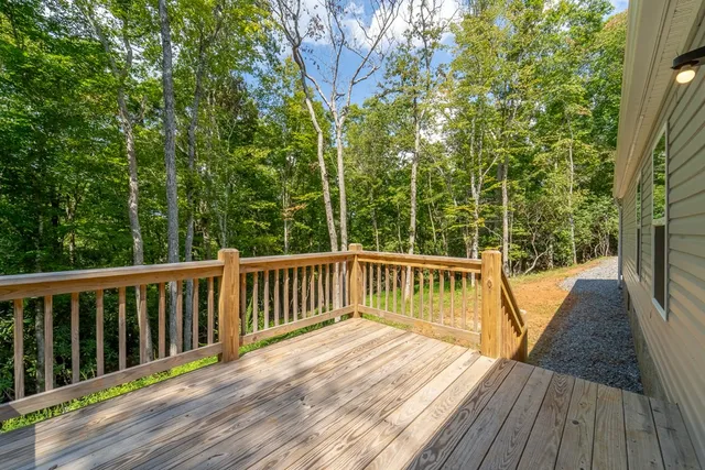 a view of balcony with wooden floor and fence