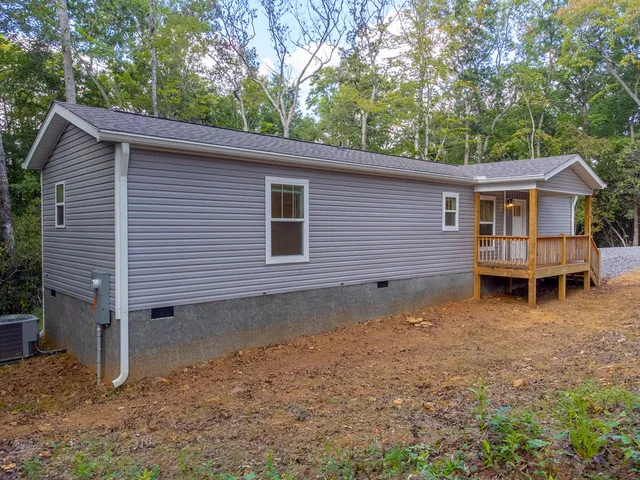 a view of a house with a yard and wooden fence