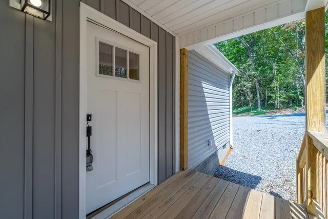 a view of a porch with wooden floor and a yard